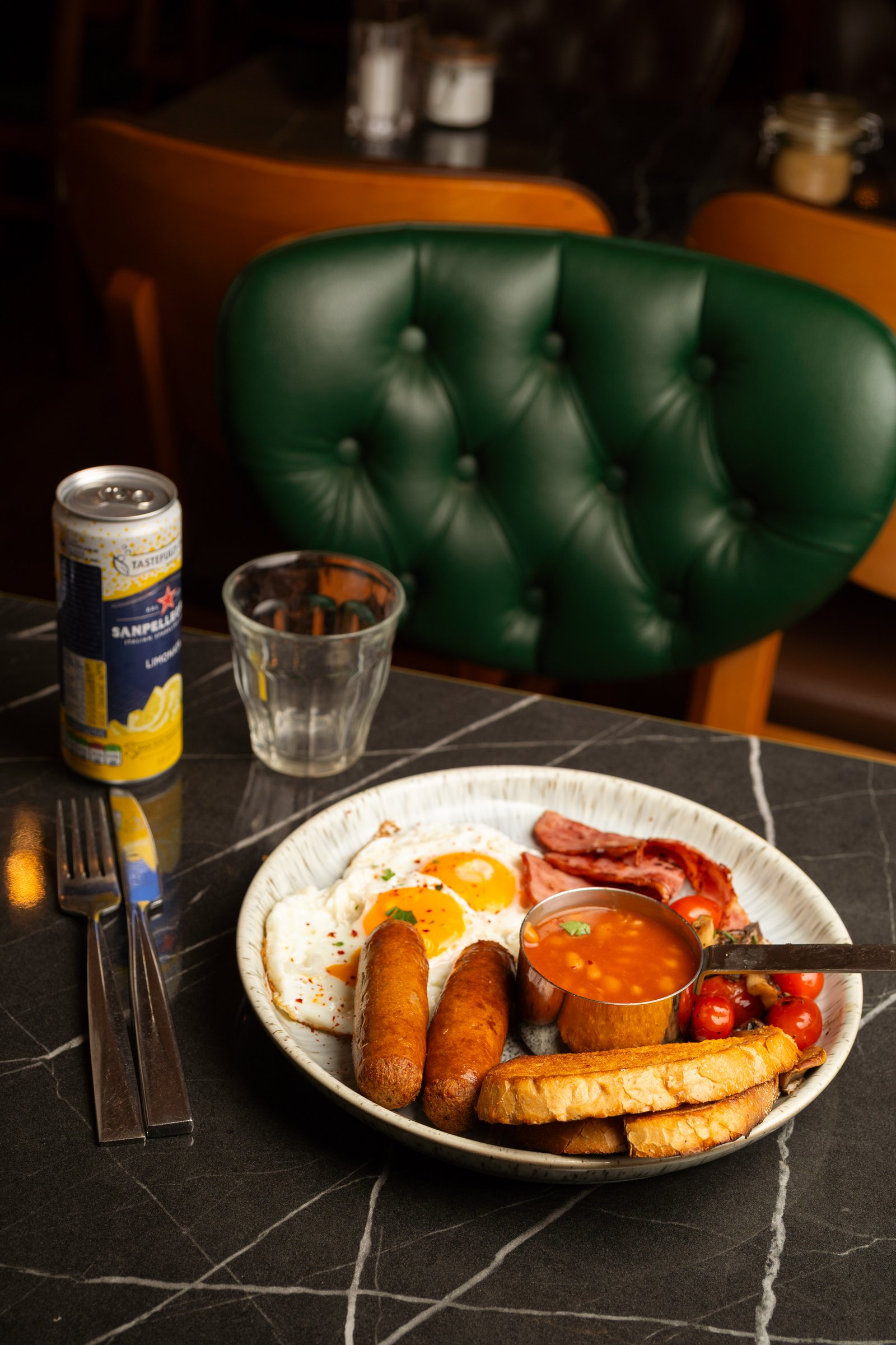 Full English breakfast plated in the green booth